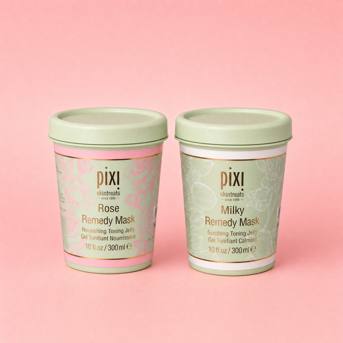 Two Pixi skincare jars of Remedy Mask, one labeled Rose and one labeled Milky, set against a solid pink background.