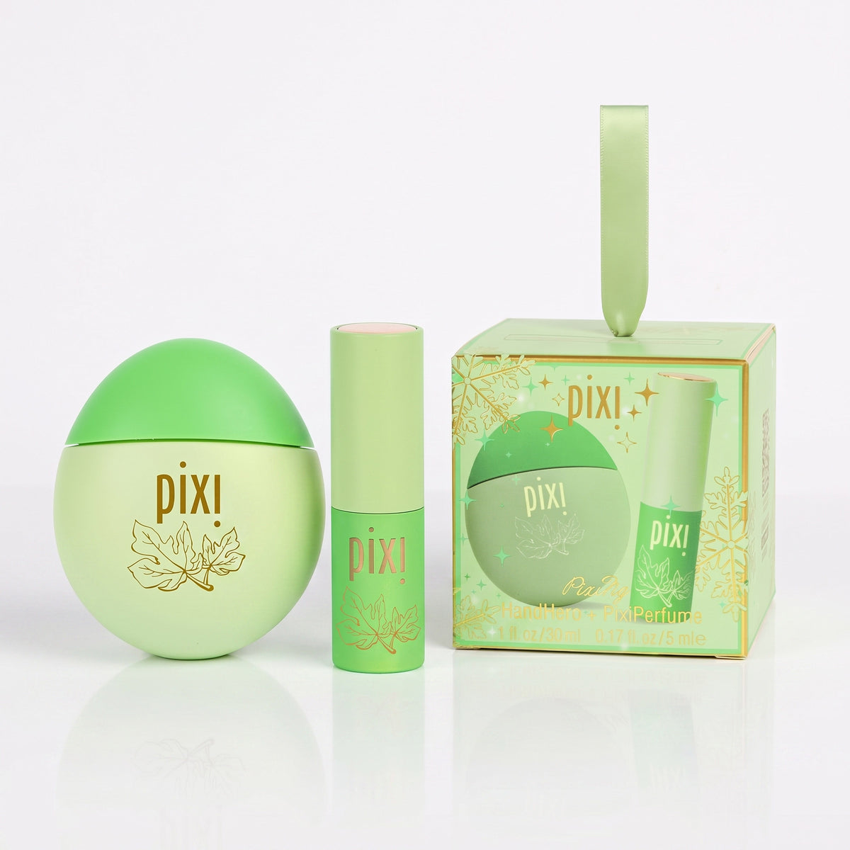 Pixi HandHero and PixiPerfume in PixiFig scented hand lotion and perfume with a light green body, gold rose graphic, and a pink cap, set against a plain white background.