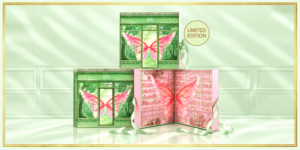 Three Pixi 'Limited Edition' advent calendar boxes arranged on a glossy surface against a pale mint green tiled background. One box is closed, showing green artwork with pink butterfly wings, and two boxes are open to reveal pink-toned inner packaging with butterfly graphics. View 1
