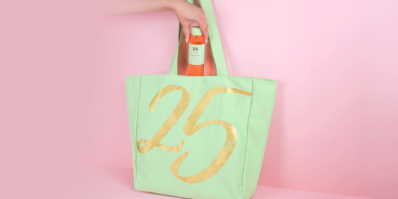 Anniversary Tote shown on a pink background with products