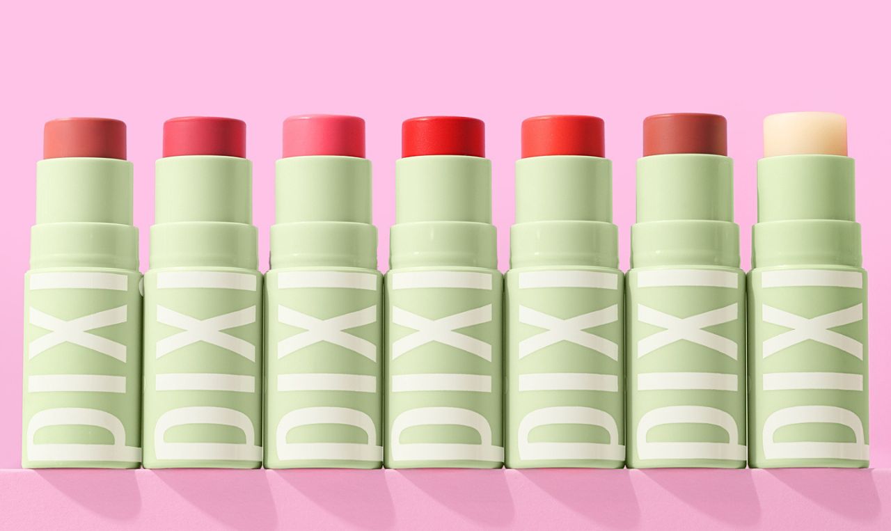 Set of +Hydra LipTreats lip balms with tinted shades on a pink background