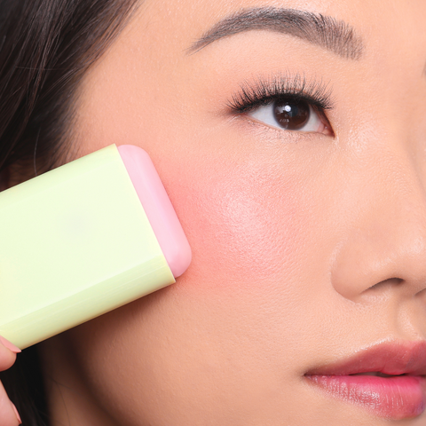 Model wearing Pixi On-the-Glow Blush for fresh natural glowing skin