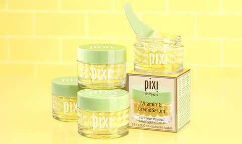 Multiple bottles of Vitamin-C CremeSerum shown on a yellow background