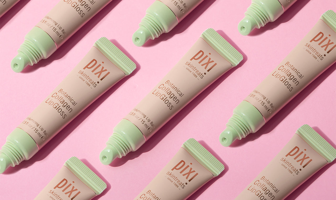 Pixi lip gloss tubes on a pink background