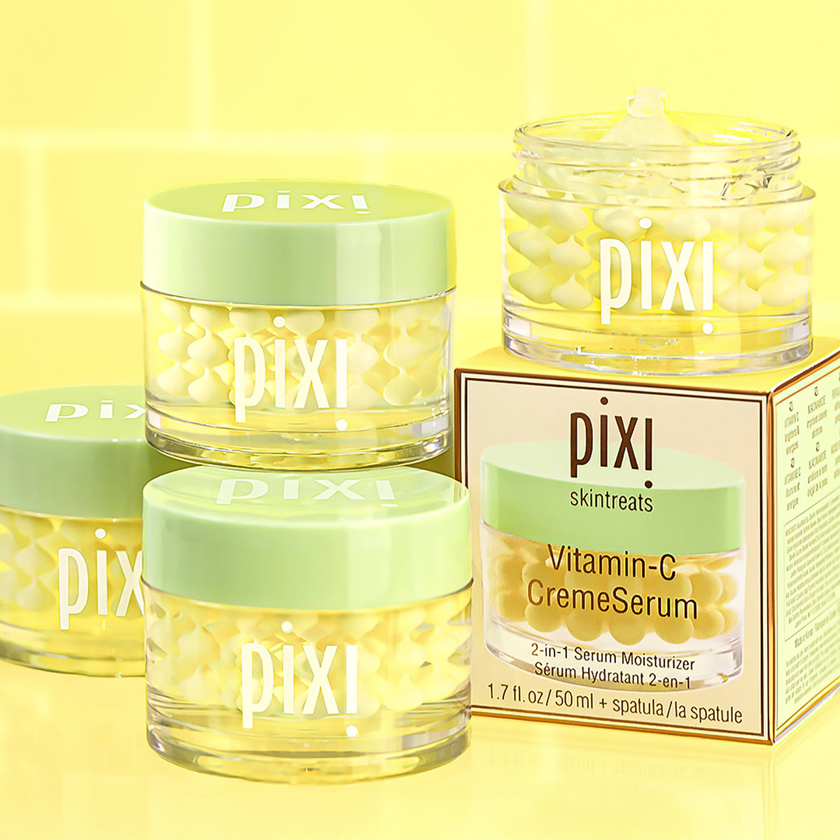 Brightening vitamin C moisturizer for radiant skin.  Multiple bottles of Vitamin-C CremeSerum shown on a yellow background