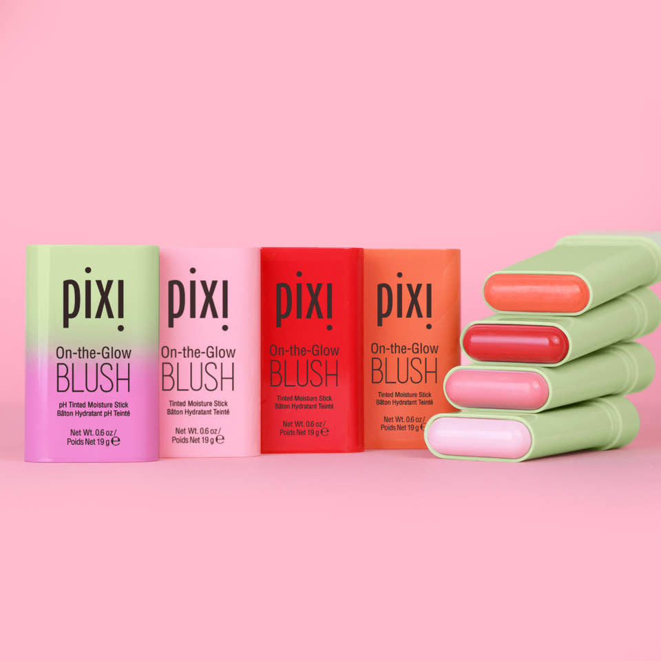 Pixi On-the-Glow Blush sticks in assorted colors against a pink background view 1