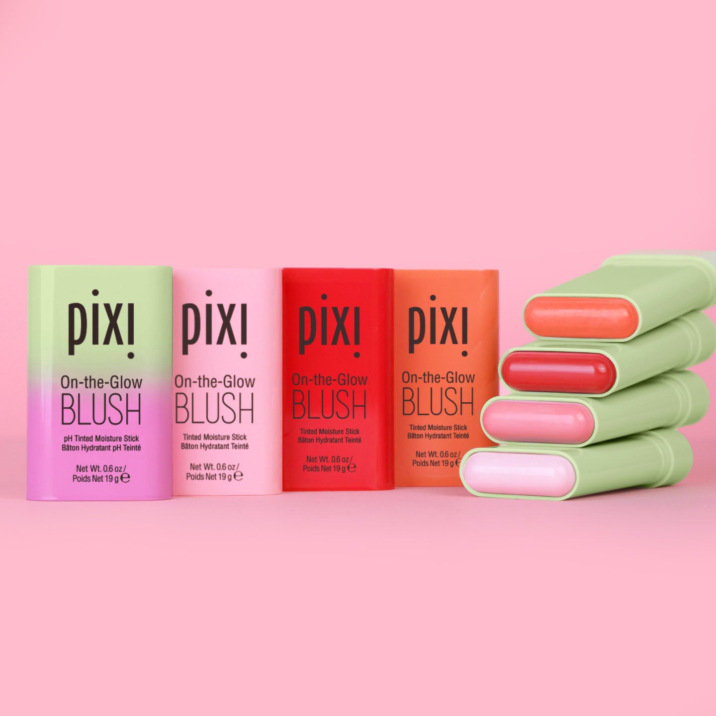 Pixi On-the-Glow Blush sticks in assorted colors against a pink background