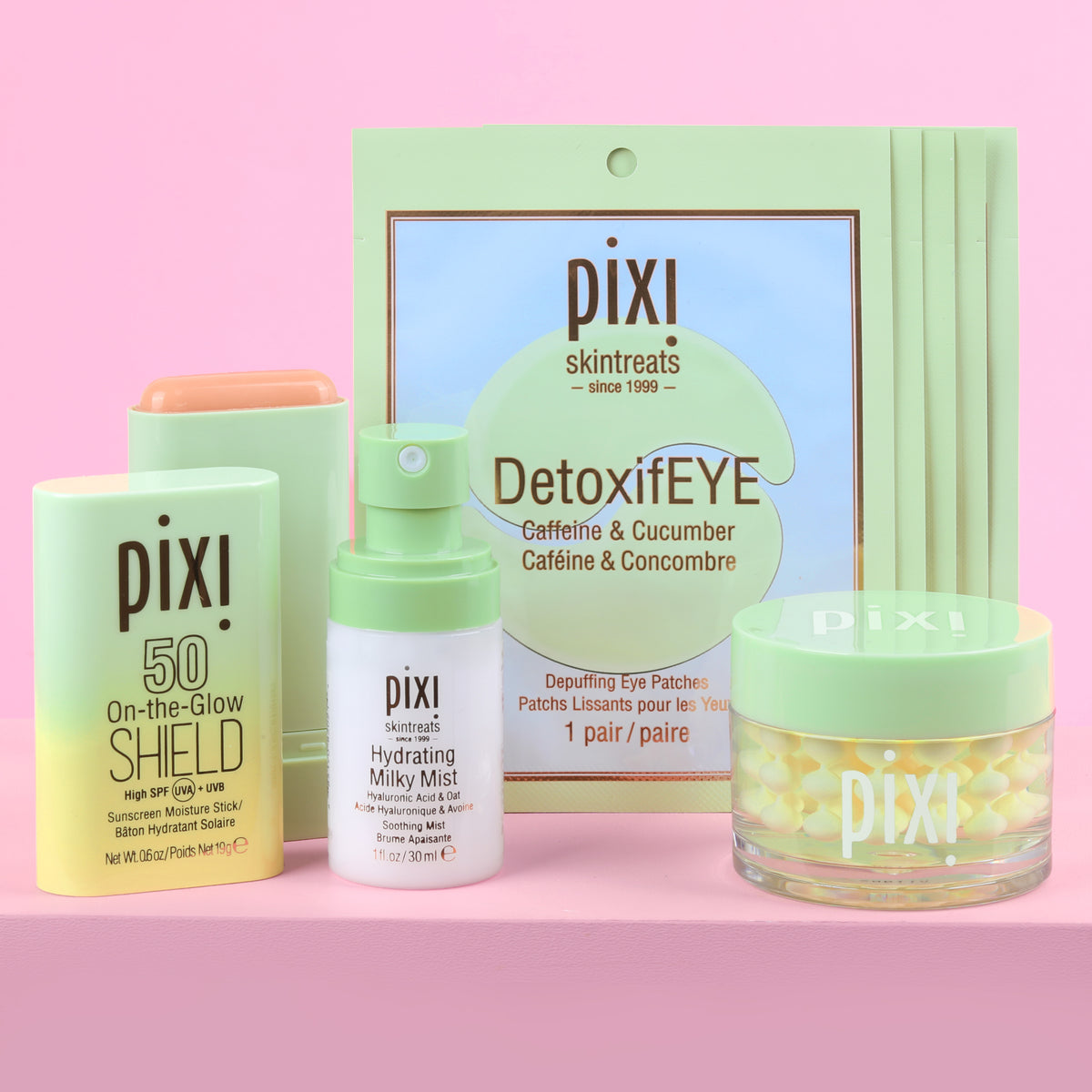 Petra's Travel Glow bundle includes Hydrating Milky Mist, DetoxifEYE Depuffing Eye Patches 5 pair, On-the-Glow SHIELD SPF 50, Vitamin-C CremeSerum on pink background.