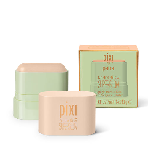 Pixi by Petra On-the-Glow Superglow highlighter stick shown with its peach-colored packaging box and two compact stick containers, one in a pale sage green case and one in a peach-beige case, on a clean white background. view 1