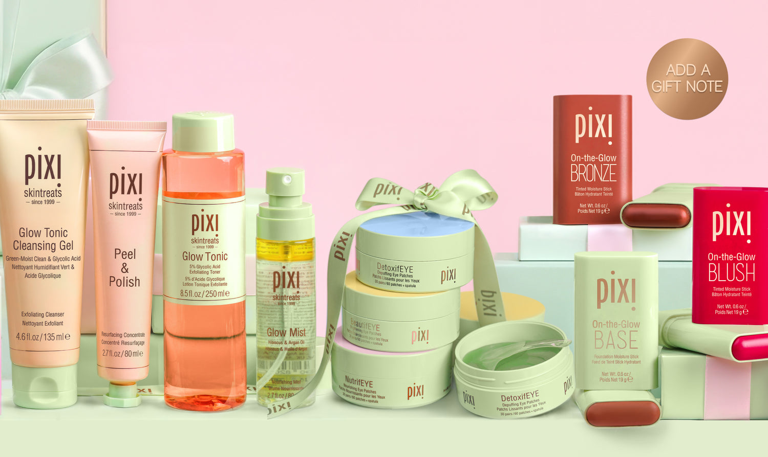 Pixi skincare products on a pink background with gifting boxes and "add a gift note" sticker