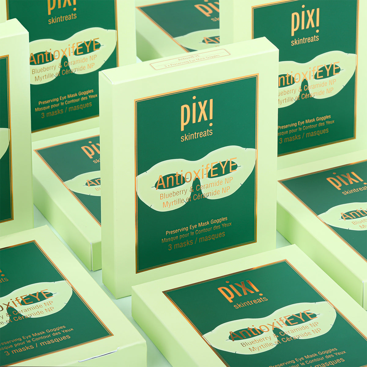 Multiple boxes of Pixi Antioxidant Eye skincare product on a light green background