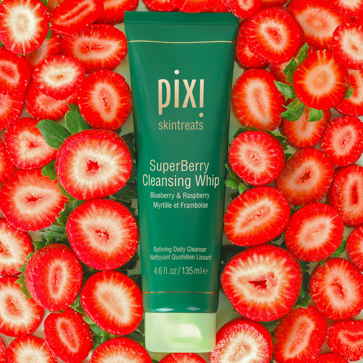  PIXI SuperBerry Cleansing Whip tube surrounded by sliced strawberries