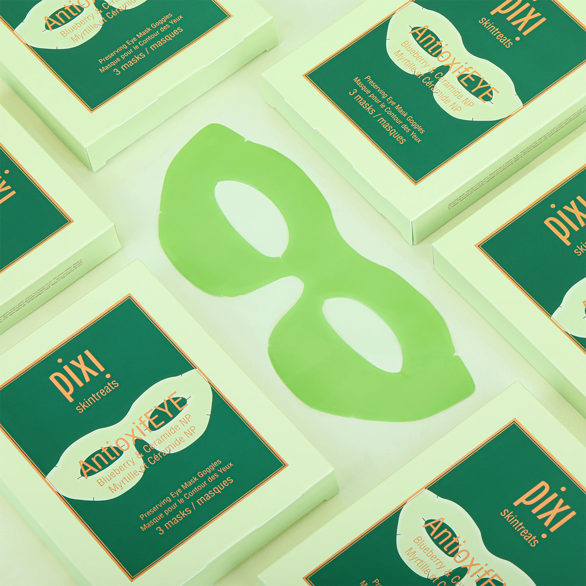 Multiple boxes of Pixi Beauty Eye masks on a light green background