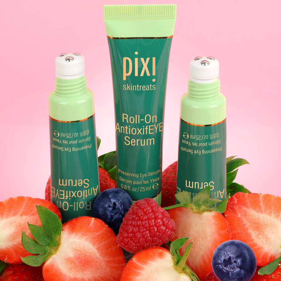 Roll-on AntioxifEYE Serum - three products with antioxidant rich fruit in background of image and showing a view of the rollerball applicator. view 2