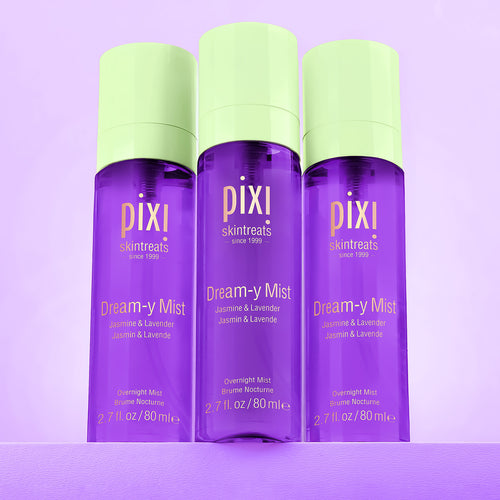 Three bottles of Pixi Dream-y Mist on a purple background view 1