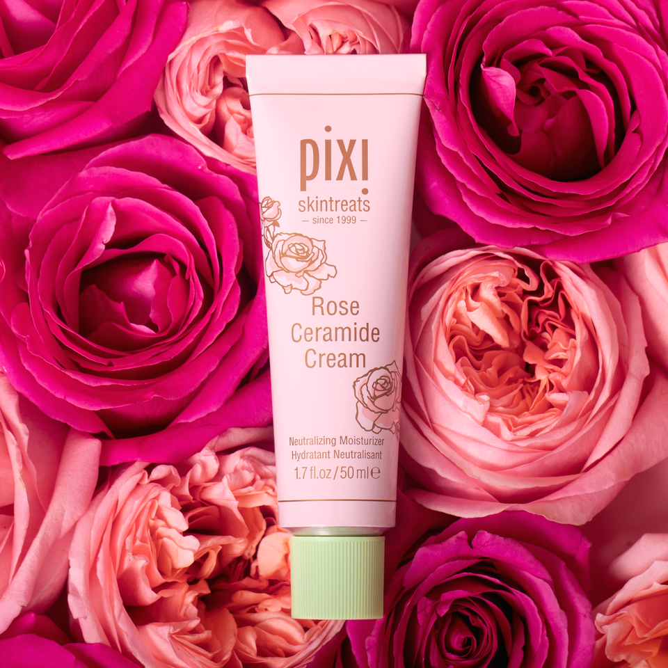 PIXI Rose Ceramide Cream tube surrounded by pink roses view 1