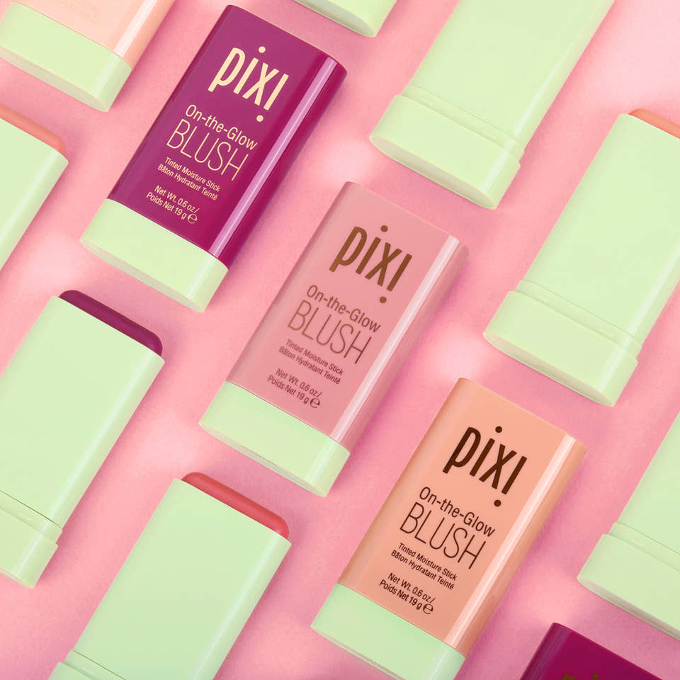 3 shades of On-the-Glow Blush shown with open lids on a pink background view 1