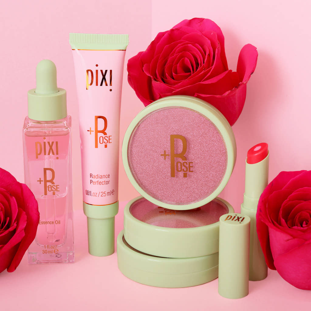 Pixi Beauty makeup products with pink roses on a pink background