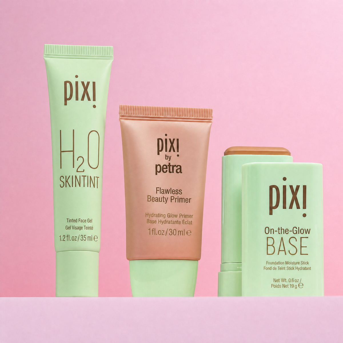 Complexion Collection bundle featuring H2O Skintint, Flawless Beauty Primer and On-the-Glow BASE shown on a pink background