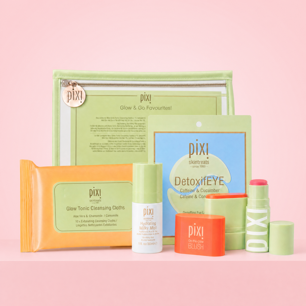 Glow & Go Favourites shown on a pink background featuring Travel Makeup Bag, Glow Tonic Cleansing Cloths, 1-Pair of DetoxifEYE Patches, Hydrating Milky Mist, On-the-Glow BLUSH Petite and +Hydra LipTreat